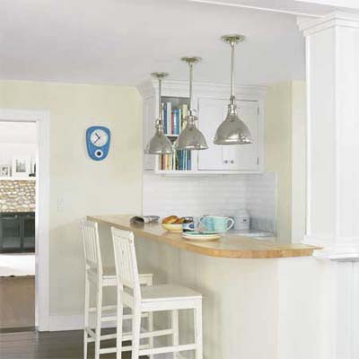 butcher block snack counter with bar stools separating the kitchen and family room 