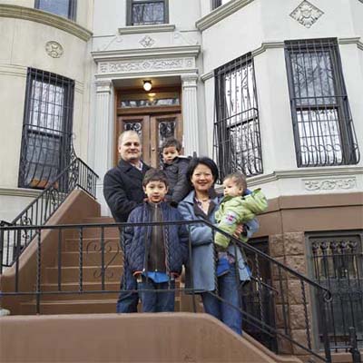new york city house homeowners standing on the stoop outside their home