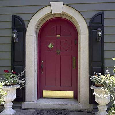 front entrance door with a sconce installed on either side