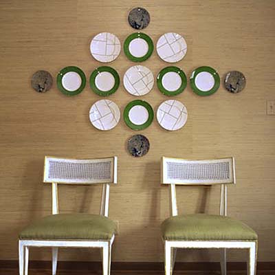 group of plates arranged in a large pattern on a wall
