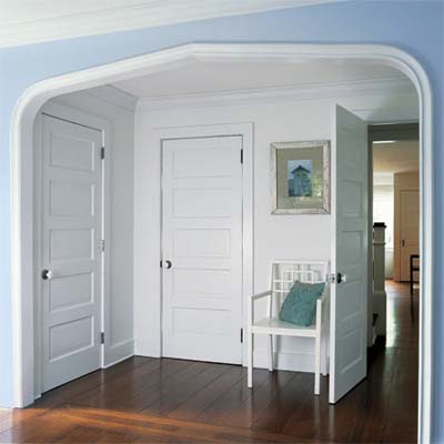 dressing area in the master bedroom built under an archway replicated from the entry hall downstairs