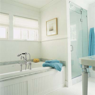 victorian style tub and old fashioned details decorate this modern master bath