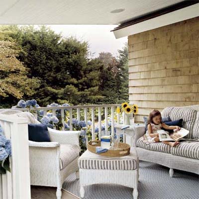 front porch with furniture, white railing and new cedar shingles