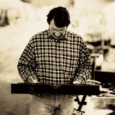 norm examining a brass bound antique level at the brimfield antique show in massachusetts