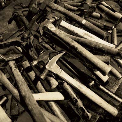 a pile of antique hammers from the brimfield antique show in massachusetts