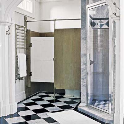 Bathroom with marble tiles and tall ceilings in former post office