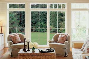 large windowed doors looking out from a living room onto a lawn