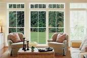 large windowed doors looking out from a living room onto a lawn