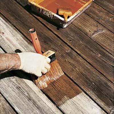 hand staining deck with a large brush