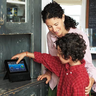 woman and young boy looking at energy control panel