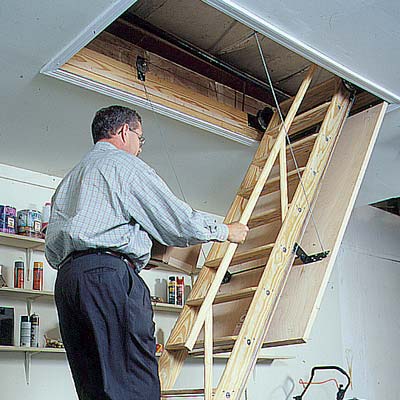 man on stairs of attic hatch