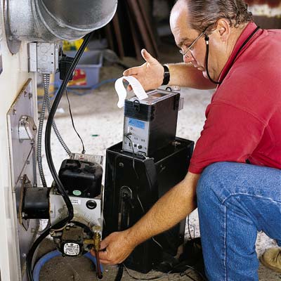 man inspecting furnace for energy efficiency