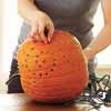 drilling designs into pumpkins nad lighting them with strings of christmas lights