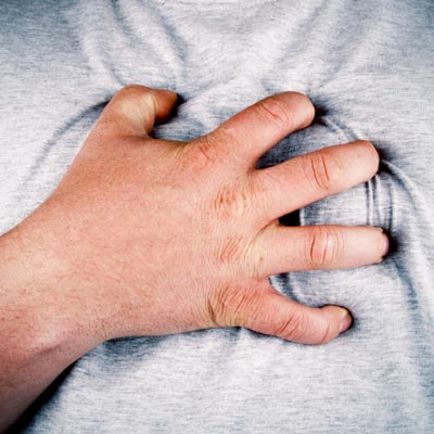 man clutching chest during heart attack