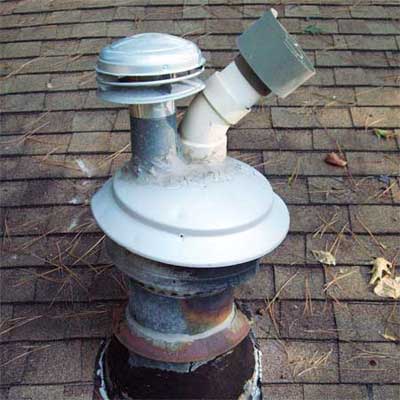 two vent flues sticking out of the old single flue