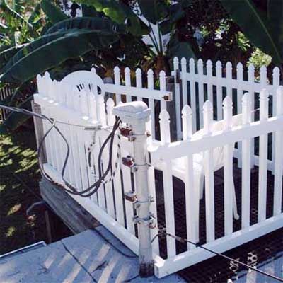 rooftop deck with chair installed immediately next to the live power lines entering the house