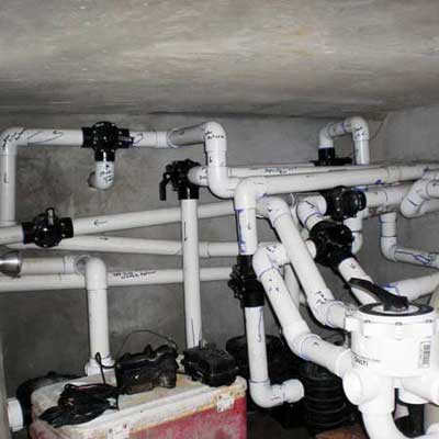 a literal maze of installed water pipes for a pool pump system