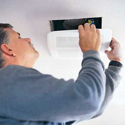 person installing an indoor air vent