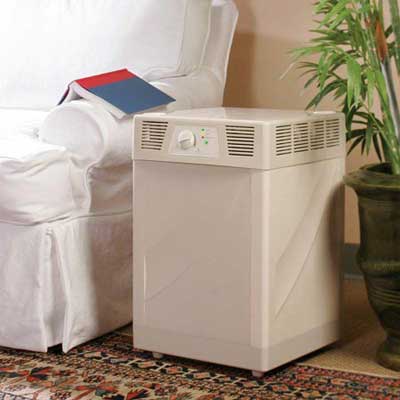 room air filter set between a couch and a potted plant