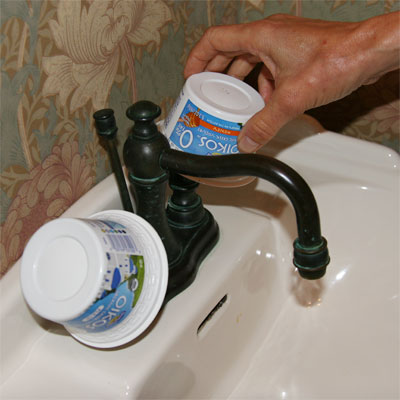 yogurt cups used to cover faucet handles