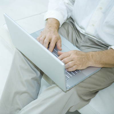 man sitting with laptop on lap