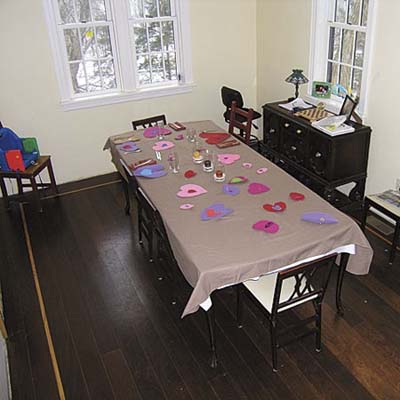 unfinished dining room with plain walls and messy table