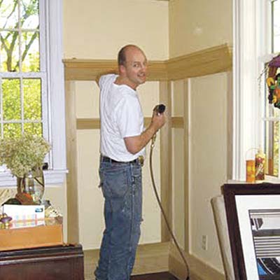 man installing wainscot panels 