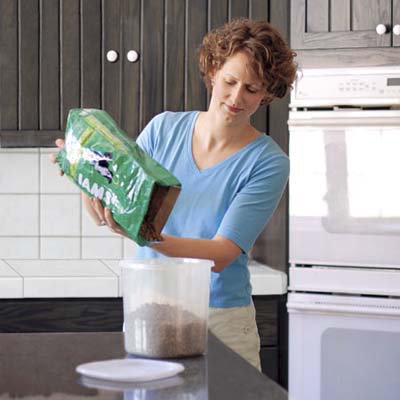 woman pouring dog food into plastic container