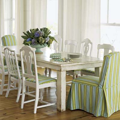 warm bright dining room table with fabric covered chairs in ample natural light