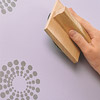 hand stamping paint on lavender walls