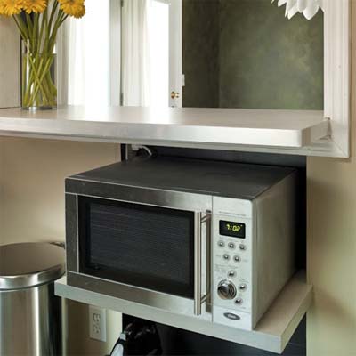 shelves added underneath the breakfast bar expand the storage space in this kitchen remodel