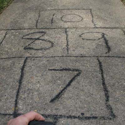 hopscotch court in driveway marked in charcoal