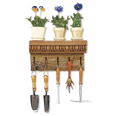 terracotta cornice used as a garden tool rack