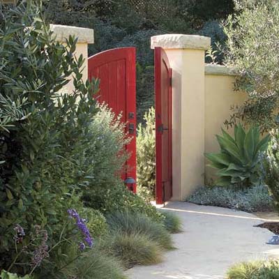 Garden entryway with bright red gate