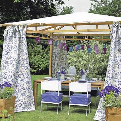 outdoor room with tented roof and fabric curtains
