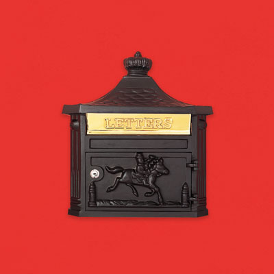 a black colored aluminum wall-mount mailbox with a brass flap