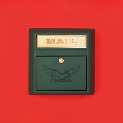a dark green powder-coated aluminum wall-mount mailbox with an eagle embossed on the front