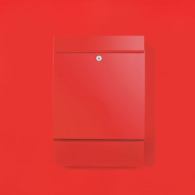 a simply designed red powder-coated painted steel wall-mount mailbox with a built-in newspaper holder