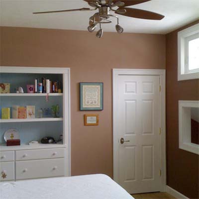 updated bedroom with built in shelves and ceiling fan