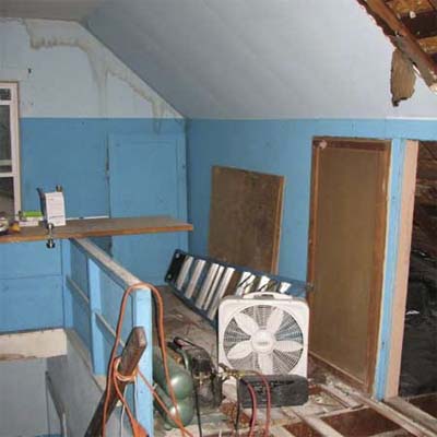 cluttered attic with sloped ceiling