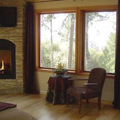 finished room with wood floors and fireplace