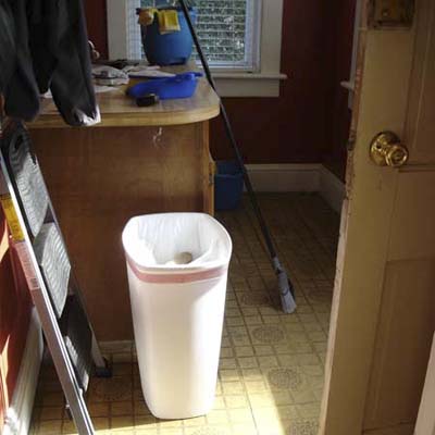 unfinished room with trash can