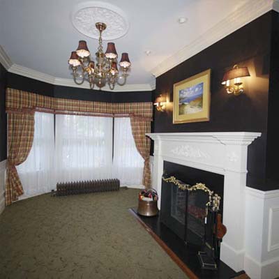 refinished living room with chandelier and fireplace