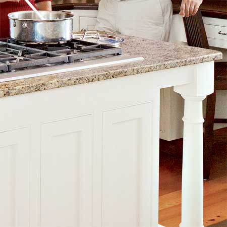granite topped kitchen island in this remodeled greek revival