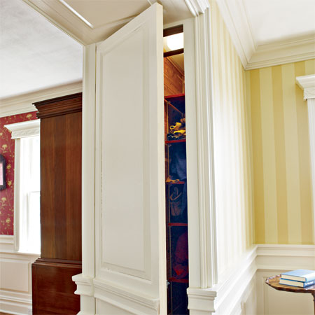 closets hidden in the wide partitions of the master suite in this remodeled greek revival