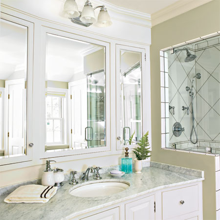 triptych mirror vanity hangs in the master bath of this remodeled greek revival