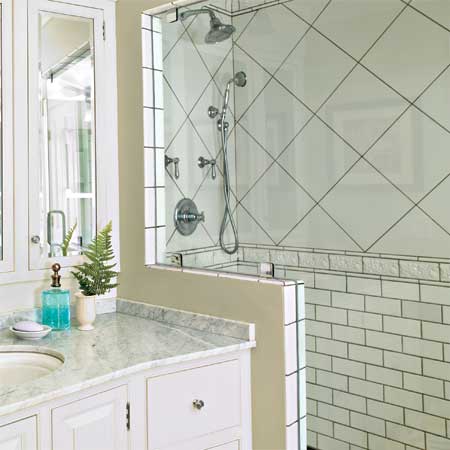 subway tile and a modern shower in the master bath of this remodeled greek revival
