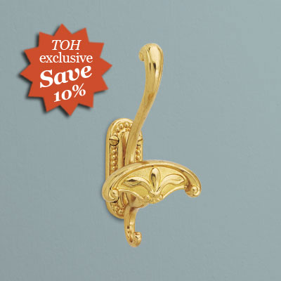 an ornate robe hook from Omnia Industries in lacquered polished brass