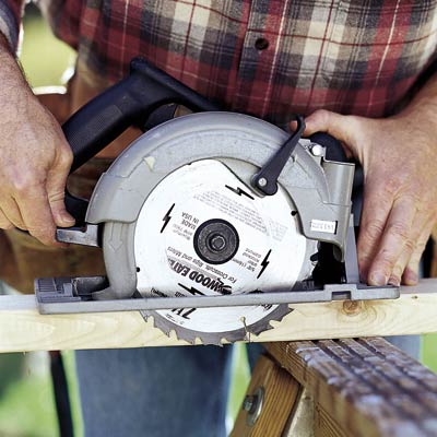 man using circular saw and setting blade depth