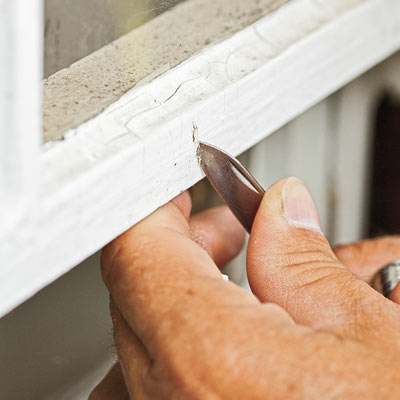 hand cutting exterior paint to check for lead